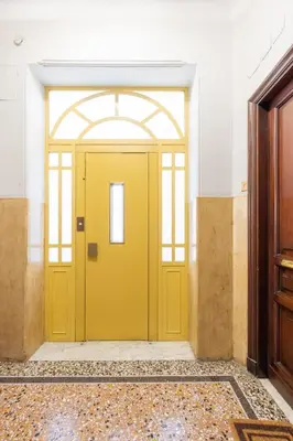a yellow door in the middle of a room at Incanto al Colosseo - Terrace retreat in Rome