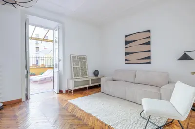 a white living room with a couch and a chair at Incanto al Colosseo - Terrace retreat in Rome