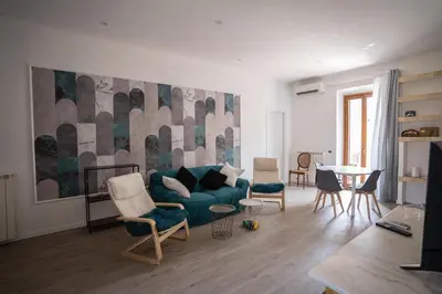 a living room with a blue couch and chairs at Torpigna Rainbow in Rome