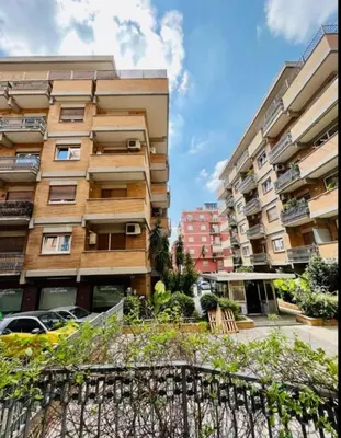 an apartment building with cars parked in front of it at Amazing Roma Vaticano in Rome
