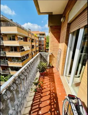 a balcony with a railing next to a building at Amazing Roma Vaticano in Rome