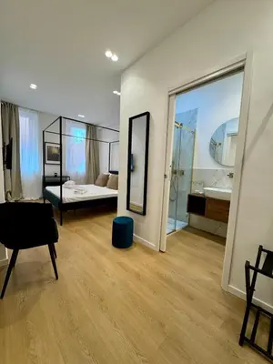 a room with a bedroom and a bed and a mirror at Scala 37 interno 2, Trastevere, Rome in Rome