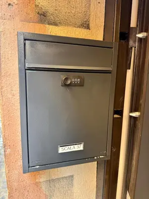 a metal door with a sign that reads security at Scala 37 interno 2, Trastevere, Rome in Rome