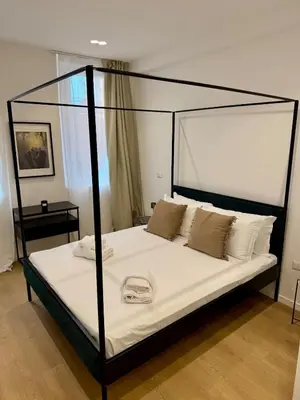 a bedroom with a canopy bed with white sheets at Scala 37 interno 2, Trastevere, Rome in Rome
