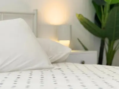 a white pillow sitting on top of a bed at Trastevere Home in Rome