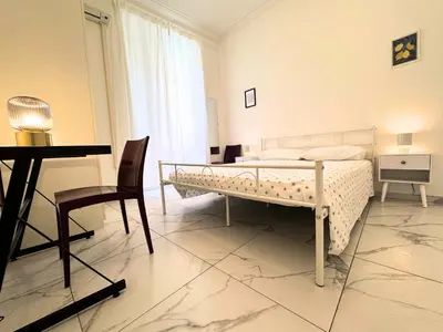 a bedroom with a bed and a table and chair at Trastevere Home in Rome