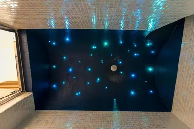 a room with a blue wall with blue lights at Domus Villae Rome Spanish Steps in Rome