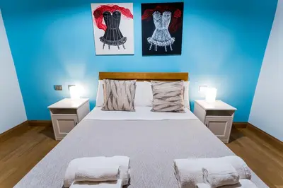 a bedroom with a large bed with two night stands at Domus Villae Rome Spanish Steps in Rome