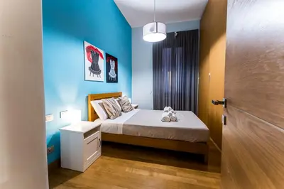 a bedroom with a bed and a blue wall at Domus Villae Rome Spanish Steps in Rome
