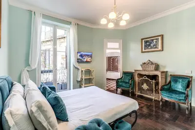 a living room with a couch and a fireplace at Barberini Apartment in Rome