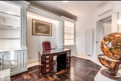 a room with a desk with a chair and a vase at Barberini Apartment in Rome