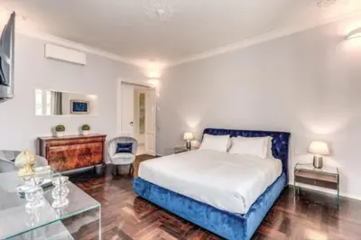 a bedroom with a king sized bed and a desk at Barberini Apartment in Rome