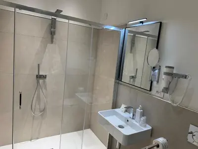 a bathroom with a shower and a sink at Settecento Guest House in Rome