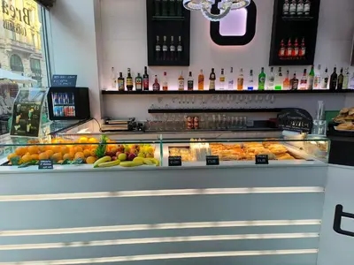 a display case in a bar with fruits and vegetables at Settecento Guest House in Rome