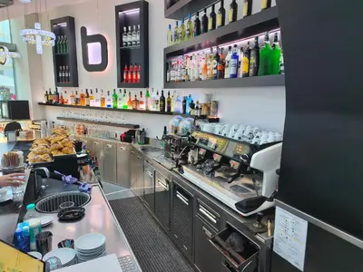 a kitchen with a bar with a coffee machine at Settecento Guest House in Rome