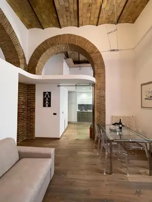 a living room with a table and a couch at Foro Romano Apartments D in Rome