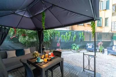 a patio with a table under an umbrella at Imperial Garden Suite - 300 m to Metro B, A-C, Rome in Rome