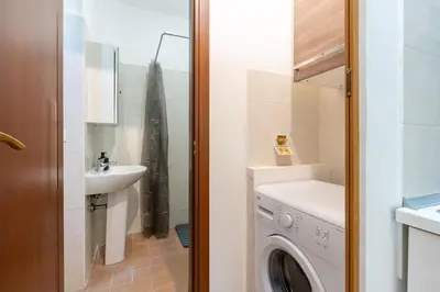 a bathroom with a washing machine and a sink at Imperial Garden Suite - 300 m to Metro B, A-C, Rome in Rome