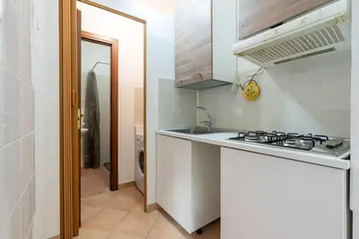 a small kitchen with a sink and a stove at Imperial Garden Suite - 300 m to Metro B, A-C, Rome in Rome