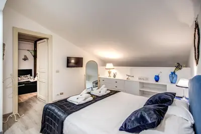 a bedroom with a large white bed with two pillows at Trevi Miracle Suite in Rome