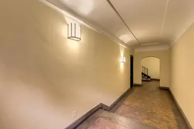 an empty hallway with lights on the wall at Trevi Miracle Suite in Rome