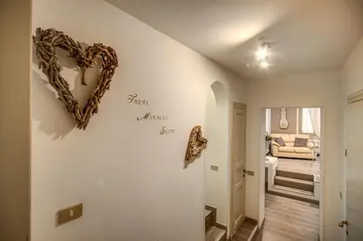 a hallway with a heart sign on a wall at Trevi Miracle Suite in Rome