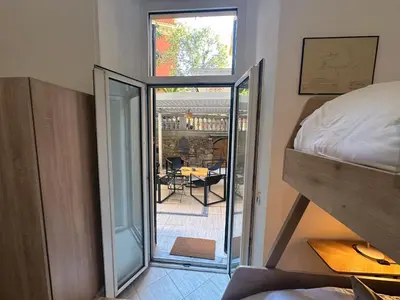 a bedroom with a bed and a view of a patio at Villa Borghese Home & Terrace in Rome