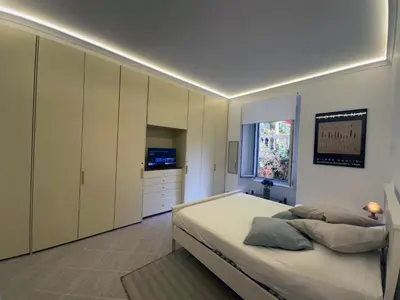 a bedroom with a bed and cabinets and a window at Villa Borghese Home & Terrace in Rome
