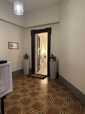 a hallway with a door and a tile floor at Villa Borghese Home & Terrace in Rome
