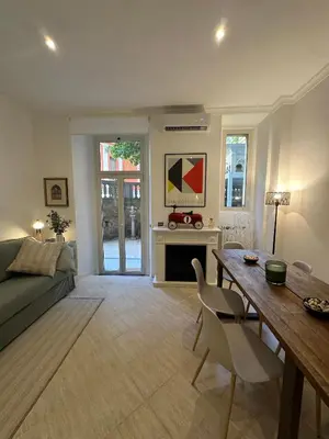 a living room with a table and a couch at Villa Borghese Home & Terrace in Rome