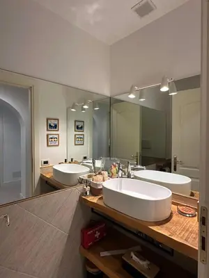 a bathroom with three sinks and a large mirror at Villa Borghese Home & Terrace in Rome