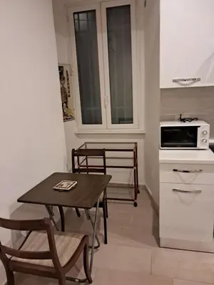 a small kitchen with a table and a microwave at Vaticano in Love in Rome