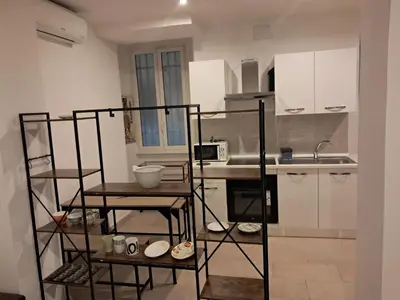 a kitchen with white cabinets and a counter top at Vaticano in Love in Rome