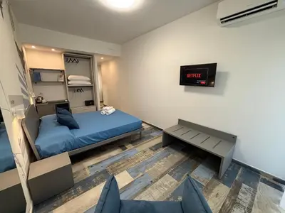 a bedroom with a bed and a clock on the wall at My Secret Room in Rome