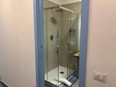 a shower with a glass door in a bathroom at My Secret Room in Rome