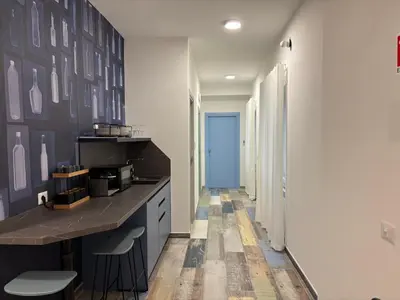 a kitchen with a counter and a blue door at My Secret Room in Rome