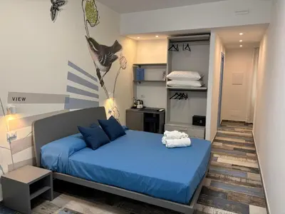 a bedroom with a blue bed in a room at My Secret Room in Rome