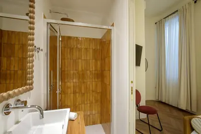 a bathroom with a shower and a white sink at Daplace - Serenella Apartment in Rome