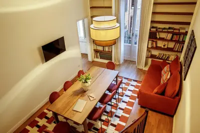a living room with a wooden table and chairs at Daplace - Serenella Apartment in Rome