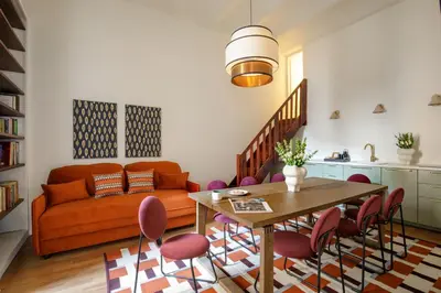 a living room with a couch and a table and chairs at Daplace - Serenella Apartment in Rome