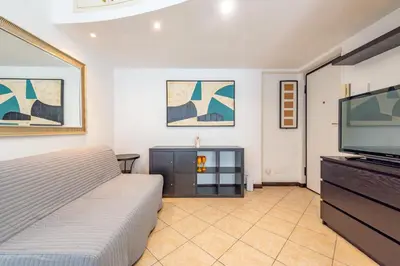 a bedroom with a bed and a flat screen tv at Domus Romana Trieste in Rome