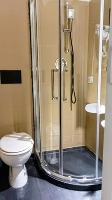 a bathroom with a shower with a toilet and a sink at little roma apartment in Rome