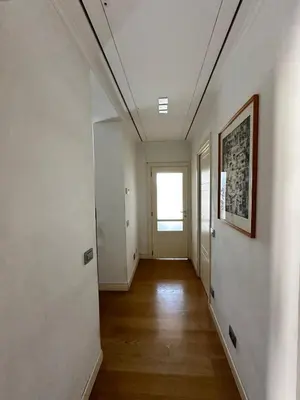 an empty hallway with white walls and a window at Roman Dream Stay in Rome