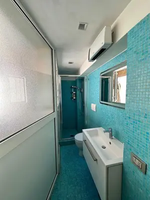 a bathroom with a sink and a toilet and a mirror at Roman Dream Stay in Rome