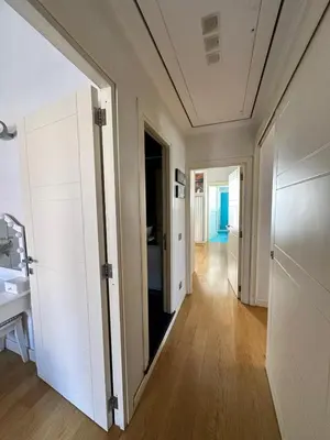 a hallway with white cabinets and a sink at Roman Dream Stay in Rome