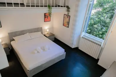 a bedroom with a bed with two towels on it at Domus Aura in Rome