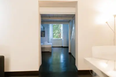 a hallway with white walls and a room with a couch at Domus Aura in Rome