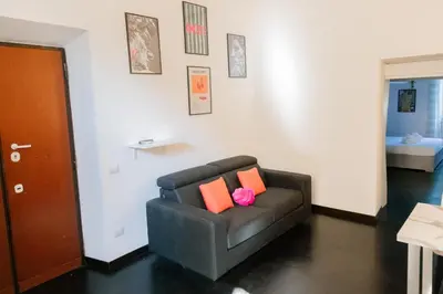 a brown couch with two orange pillows in a living room at Domus Aura in Rome