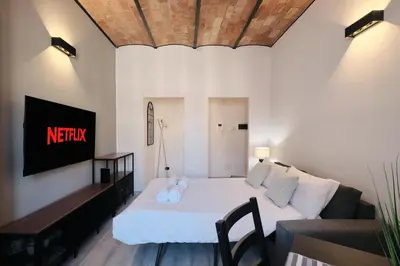 a small bedroom with a bed and a couch at Circo Massimo Suite - In the heart of Testaccio in Rome