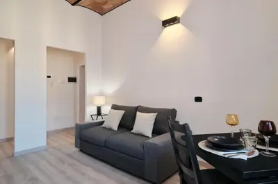 a living room with a couch and a table at Circo Massimo Suite - In the heart of Testaccio in Rome